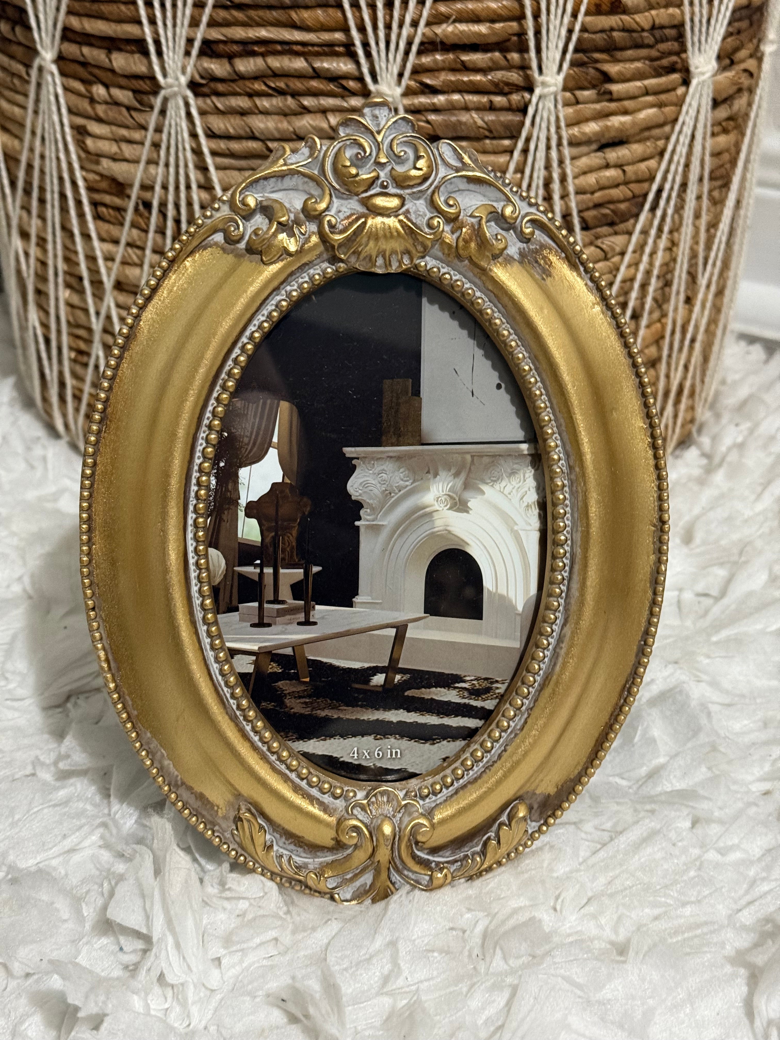 Antique gold oval baroque picture frame with rococo detailing, elegant vintage home decor accent.