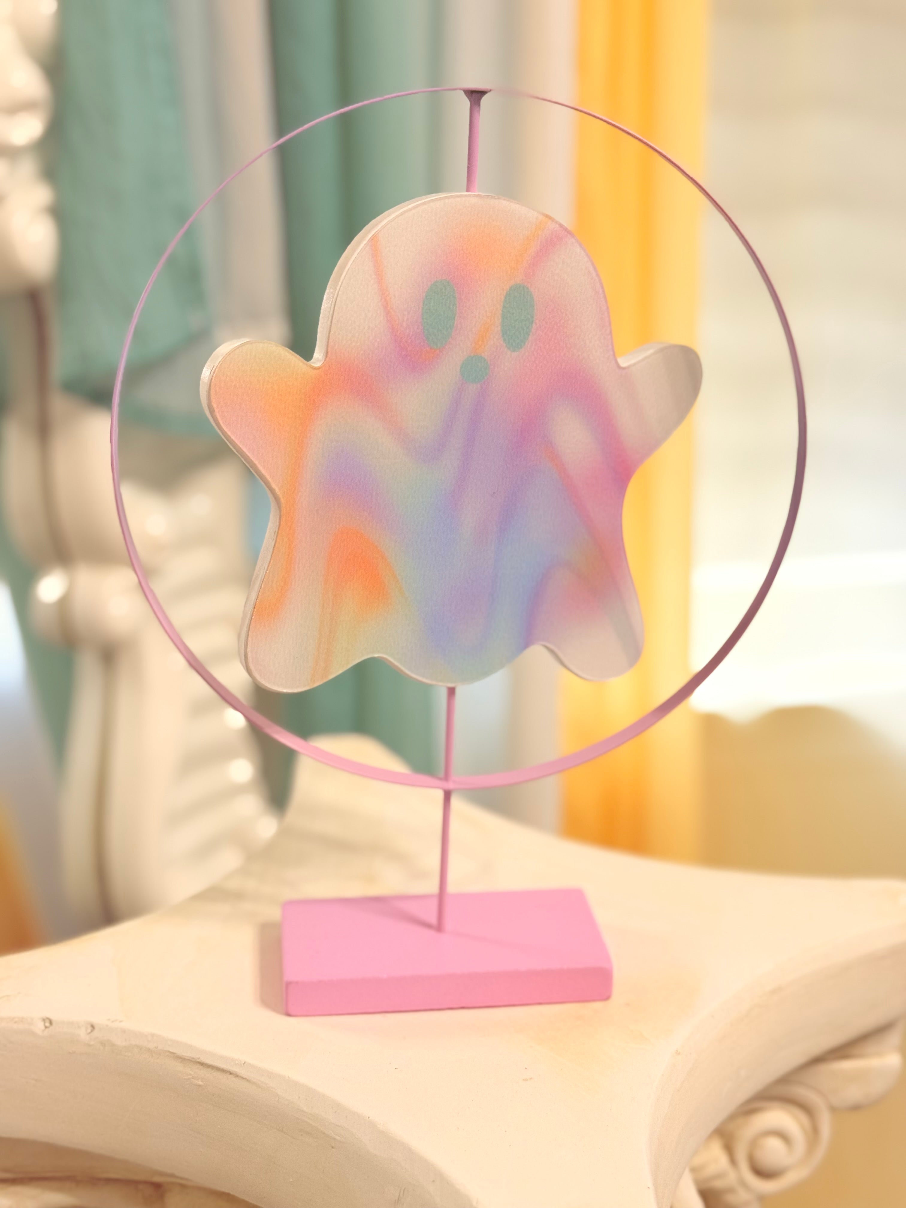 Holographic pink ghost figurine on spinning stand, cute Halloween or year-round whimsical decor accent.