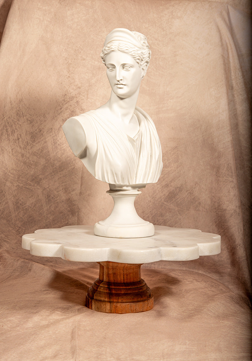 White scalloped marble cake stand with wooden base, perfect for elegant dessert display or home entertaining.