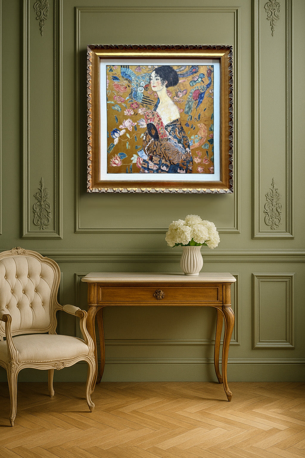 Decorative interior with a framed artwork on a green wall, a table with flowers, and a chair.