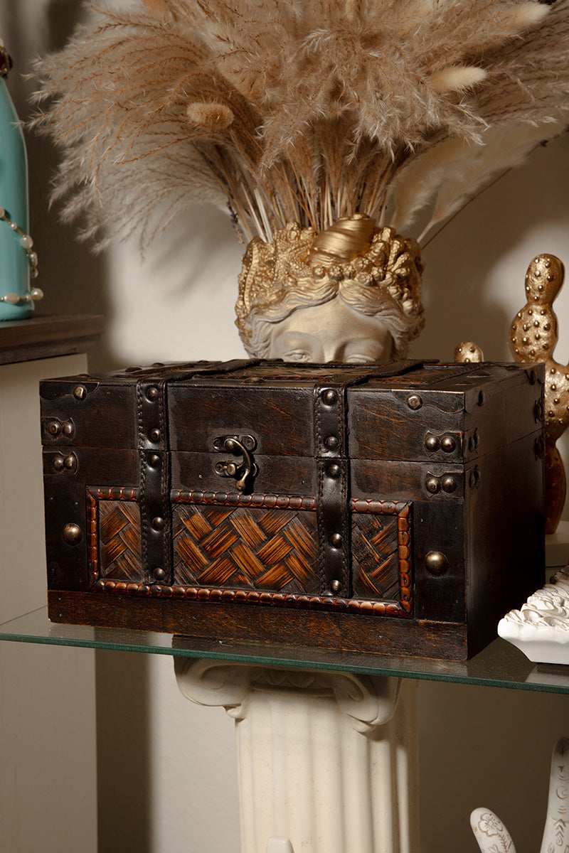 Vintage wooden treasure chest jewelry box with brass accents, antique keepsake storage decor piece.