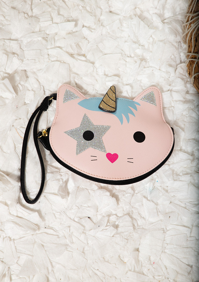 Pink cat-shaped pouch with unicorn horn and star accents on a white textured surface
