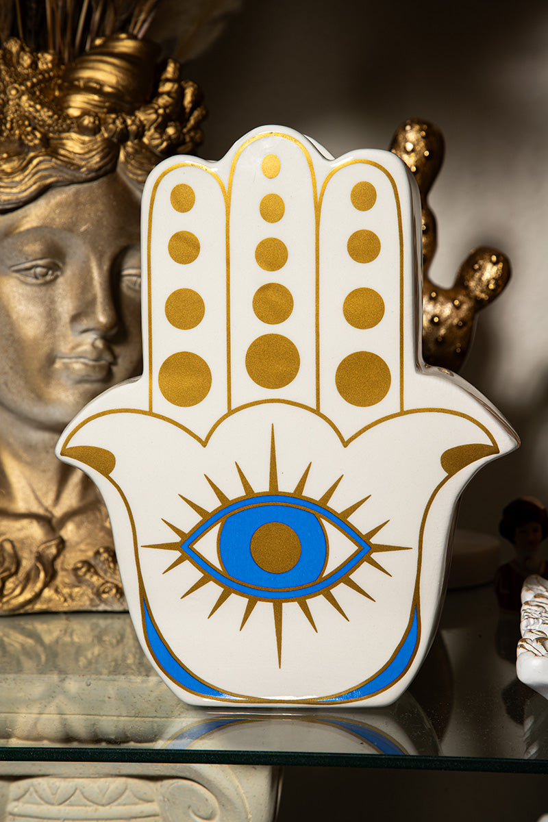White ceramic Hamsa flower vase featuring a golden all-seeing eye and boho spiritual design.