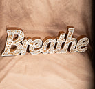 Rustic wooden “Breathe” wall sign with white mosaic detail, inspirational home decor accent.
