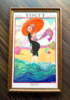 Framed Vogue Hot Weather 1919 cover art featuring woman with parasol by the sea in ornate antique gold frame wall décor.