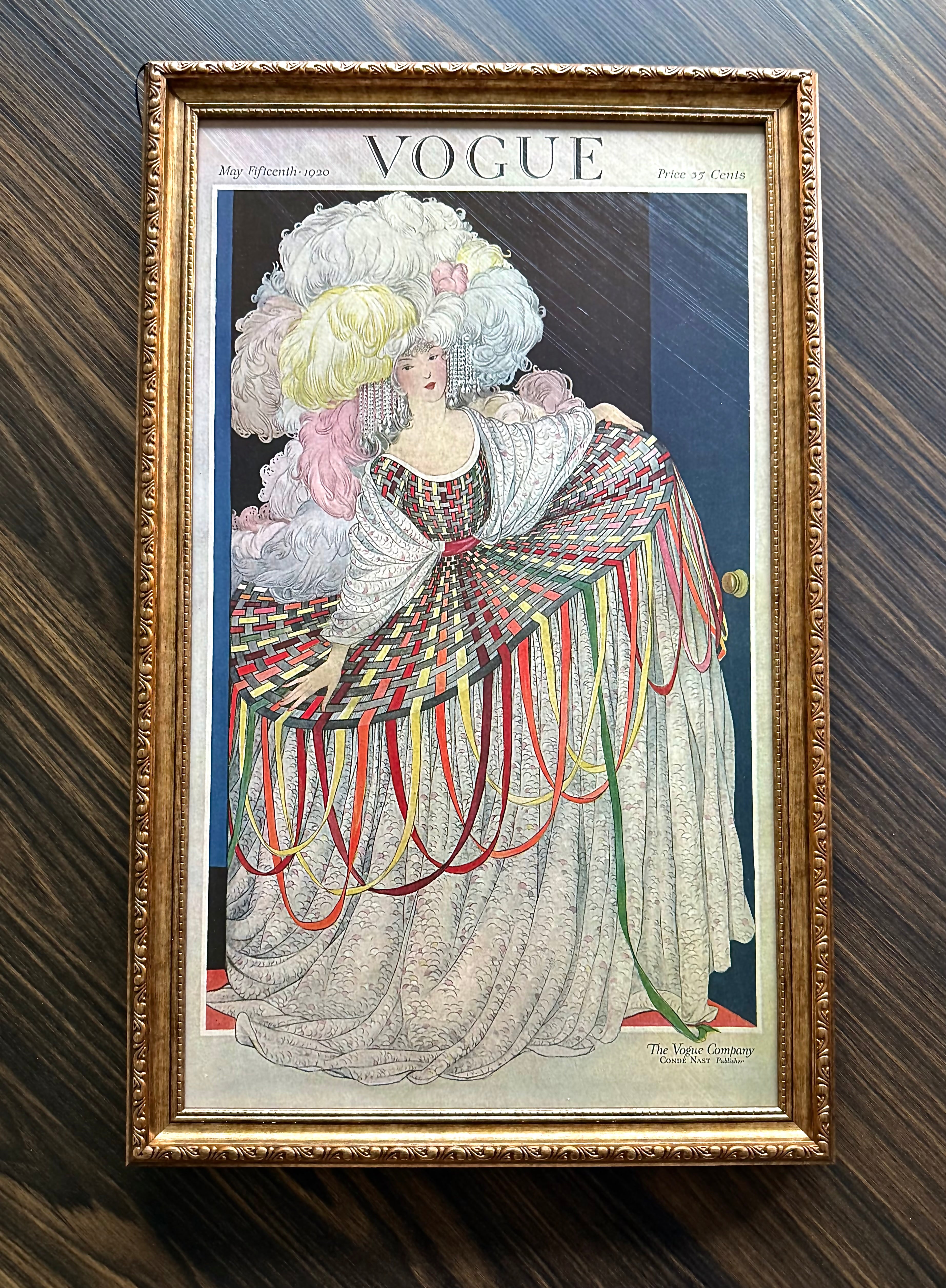 Framed Vogue May 15 1920 cover art featuring woman in ribbon gown and powdered hairstyle in ornate antique gold frame wall décor.