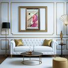 Luxurious living room with white sofa, gold accents, and framed artwork.