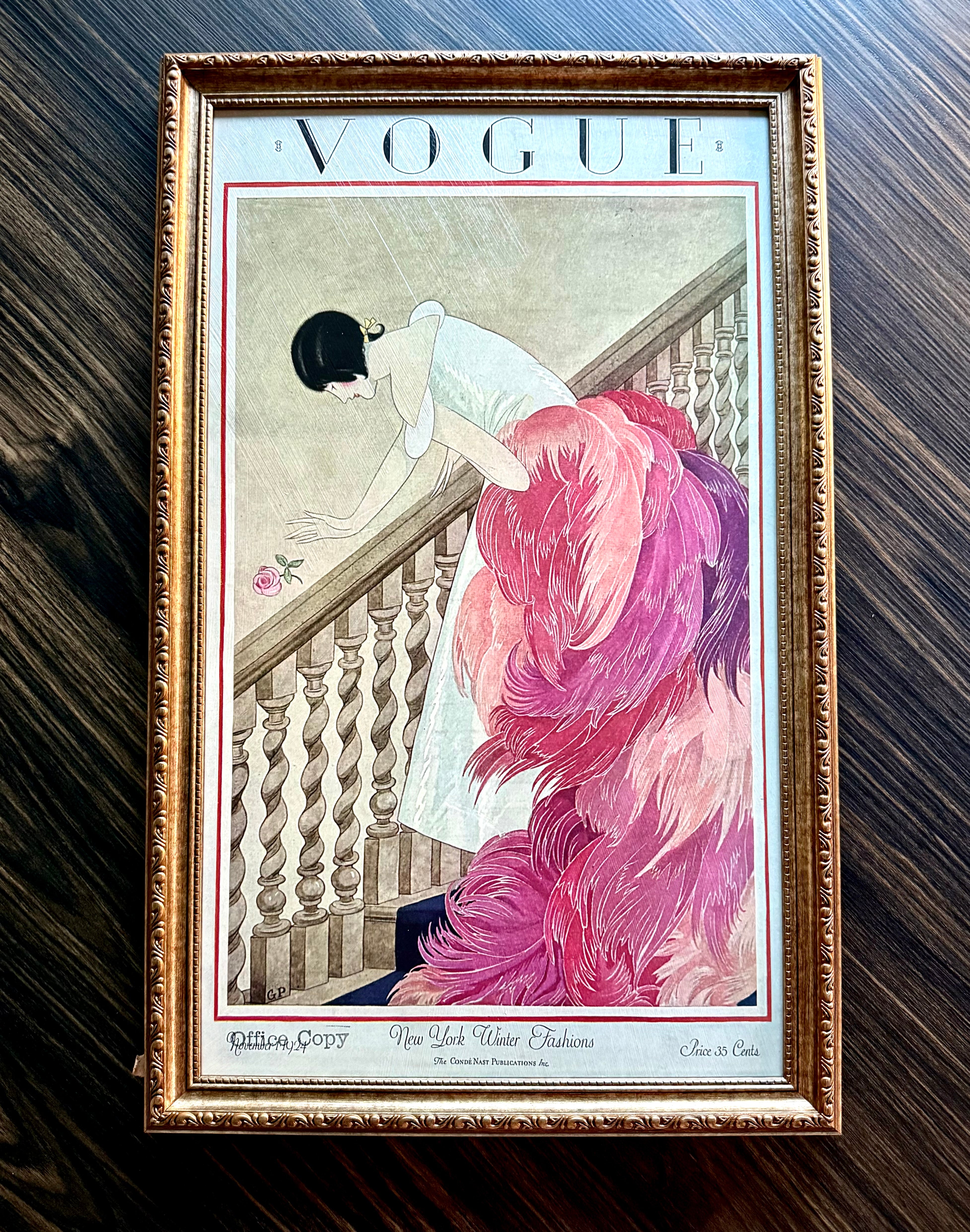 Framed Vogue New York Winter Fashions cover art featuring feathered pink gown in ornate antique gold frame, ready to hang wall décor.