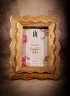 Natural wood scalloped picture frame with rustic handcrafted design for farmhouse decor.