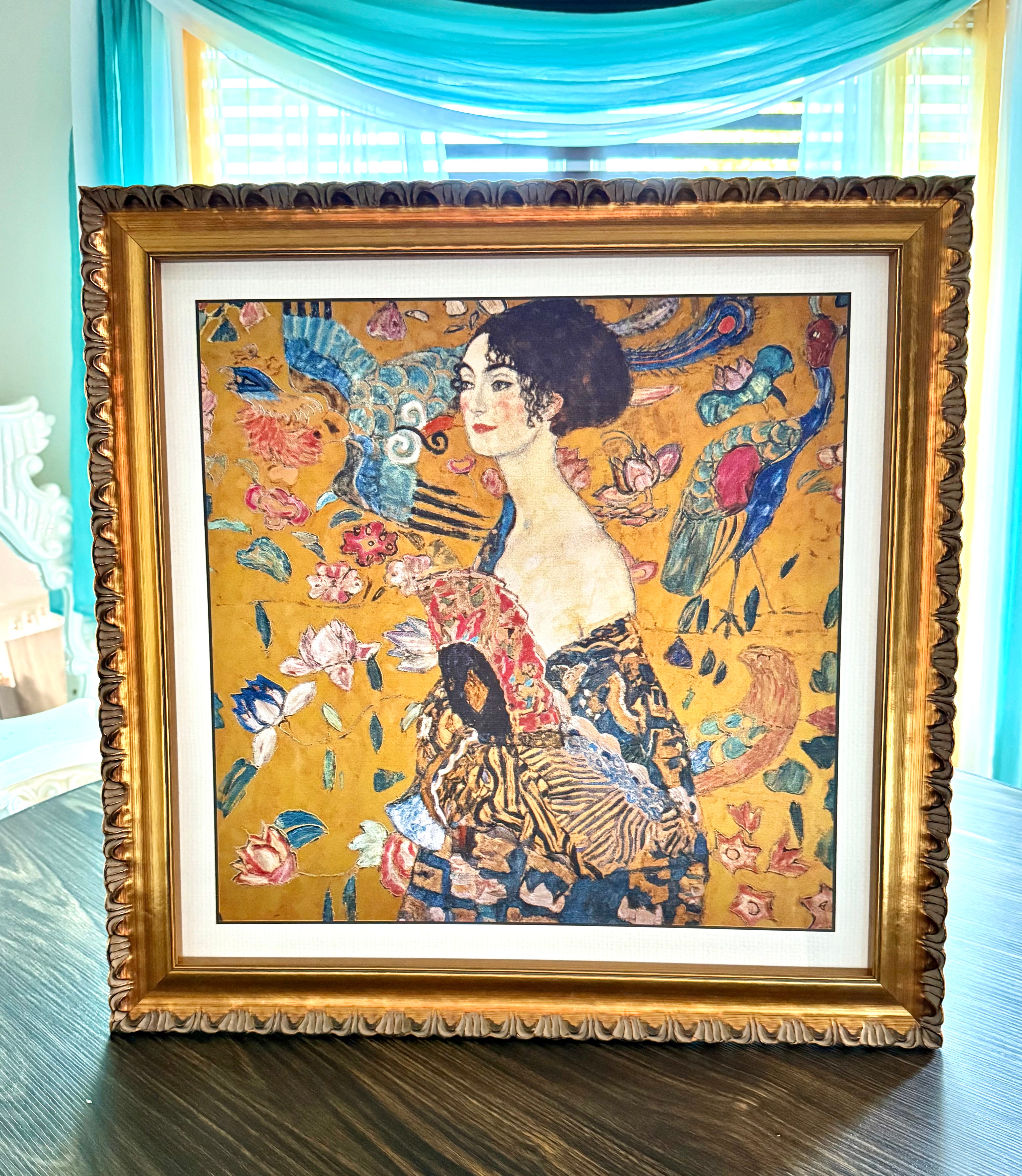 Framed artwork with a woman and floral design on a yellow background