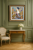 Decorative interior with a framed artwork on a green wall, a table with flowers, and a chair.
