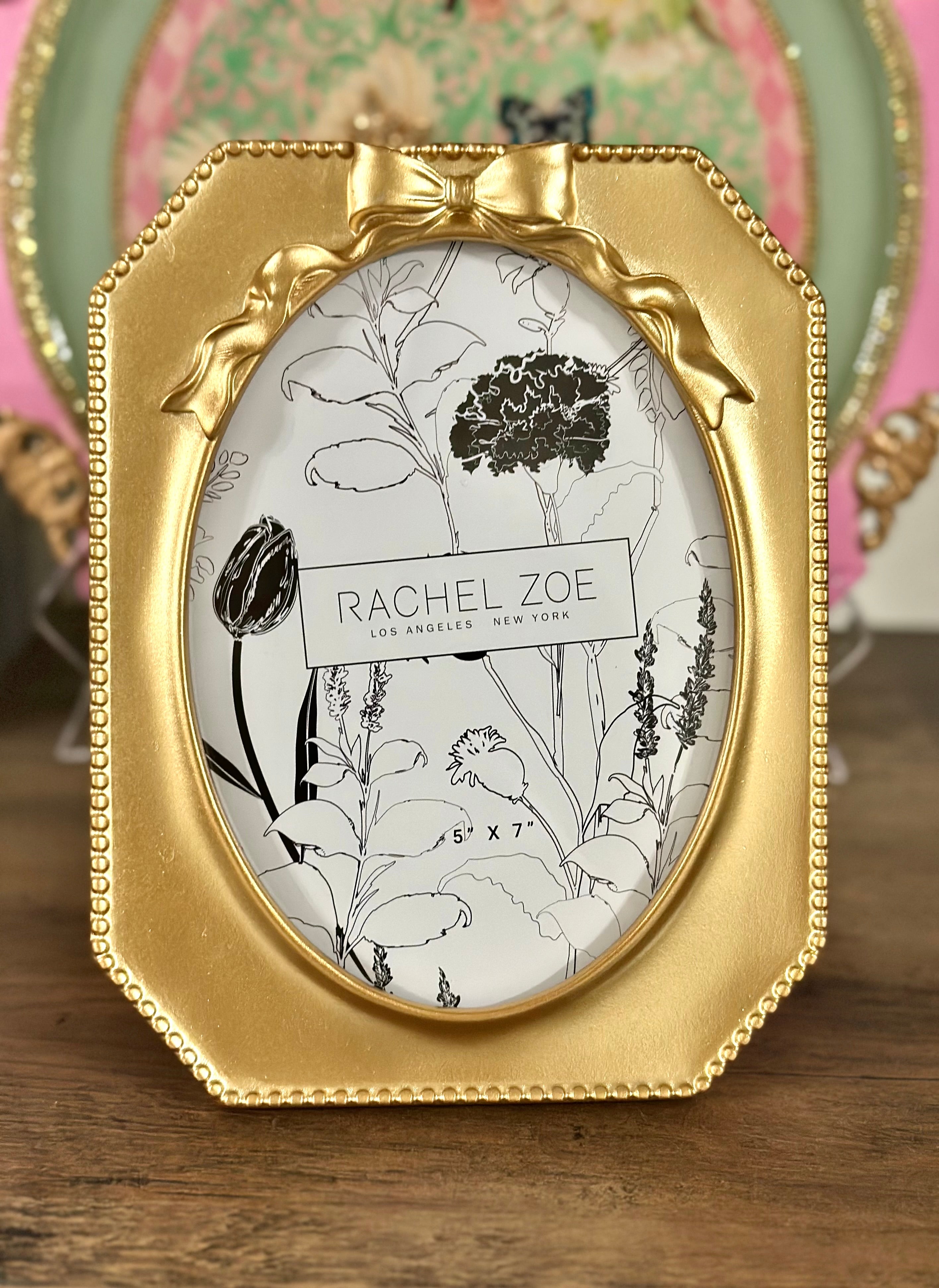 Oval octagon gold picture frame with bow detail, Rachel Zoe Hollywood vintage style.
