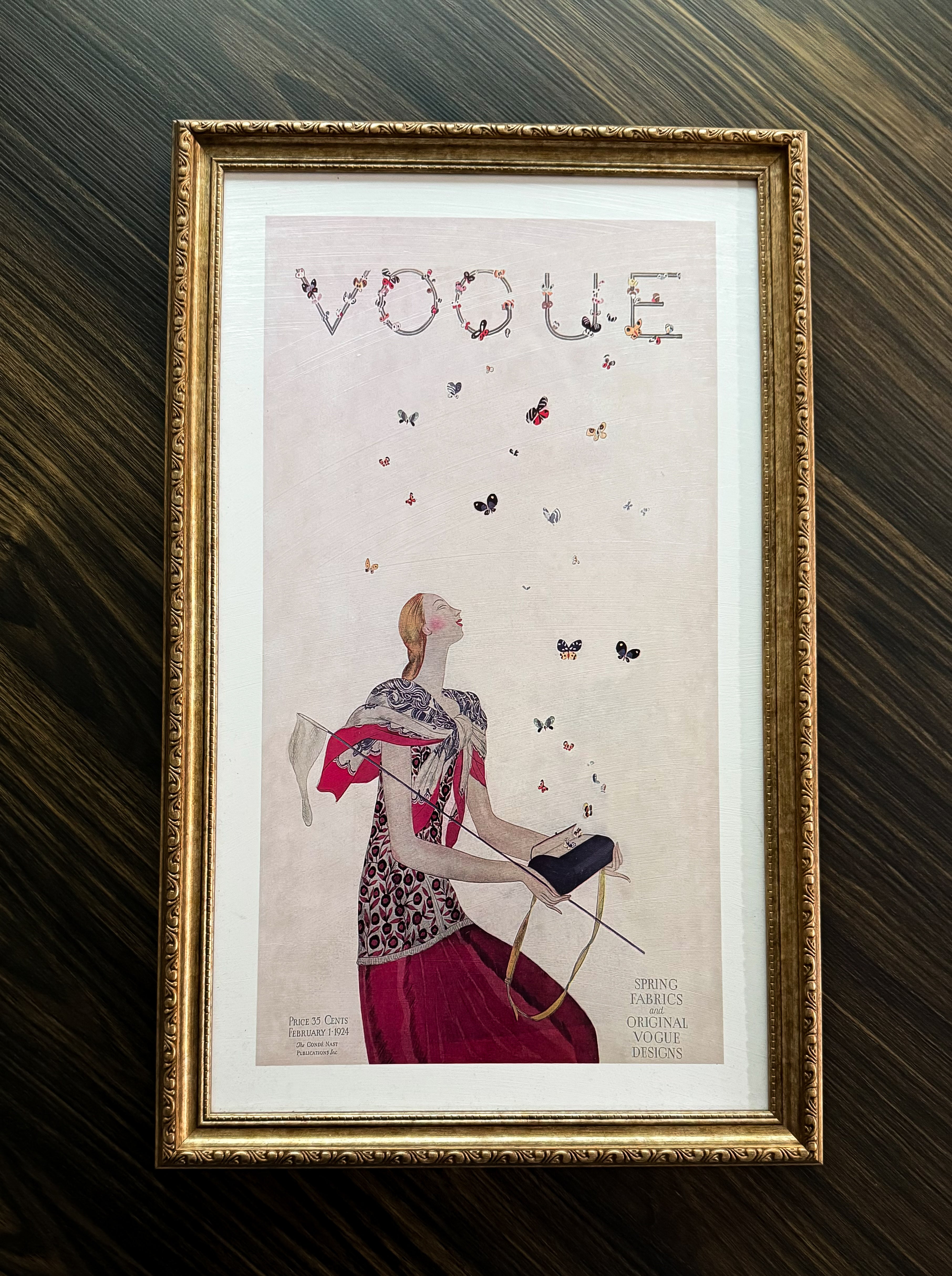 Vintage Vogue cover art print with butterflies above a stylish woman, framed in ornate antique gold frame, ready to hang décor.