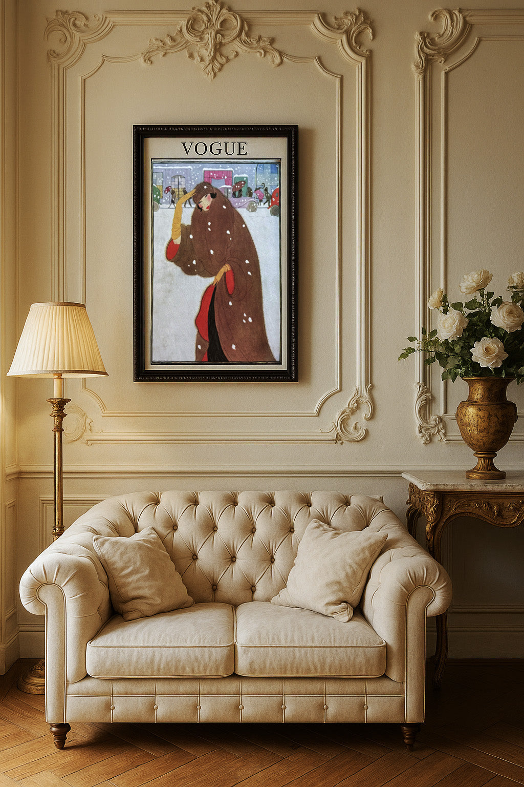Beige sofa in a room with decorative wall molding, a lamp, and a vase with flowers.