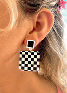 black and white checkered square acrylic earrings inspired by 80s retro racetrack fashion
