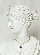 minimal gold yin and yang pendant necklace representing balance and spiritual harmony in modern style