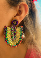 Alive with color and movement, these Mardi Gras-inspired earrings feature shimmering feathers outlined by tiny iridescent beads. Their vibrant green, gold, and violet tones echo parade lights and music, while their lightweight structure adds effortless drama. Perfect for festival looks or everyday confidence.